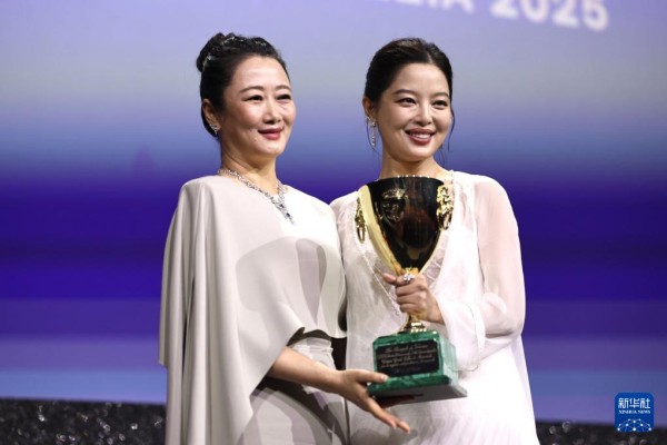 9月6日，在意大利威尼斯，辛芷蕾夺得第82届威尼斯电影节最佳女演员奖。这是主竞赛单元评委赵涛（左）为辛芷蕾颁奖。新华社记者 李京 摄