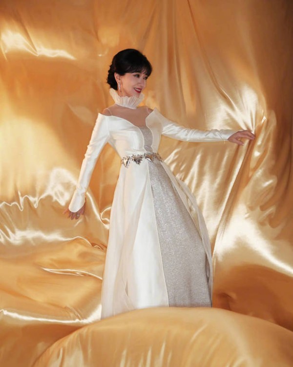 赵雅芝浅笑，在金绸背景里尽显优雅贵气。